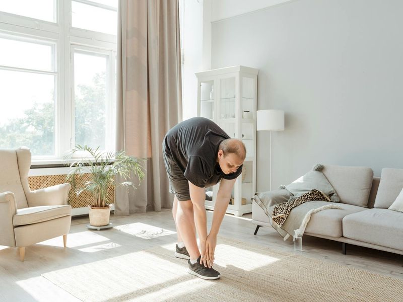 Person doing a slow stretch in a clean bright room